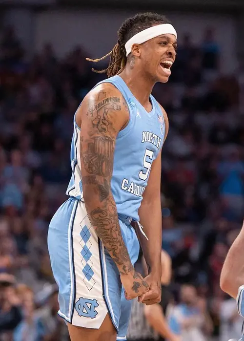 The NCAA Division player showing his religious tattoo of his right shoulder.