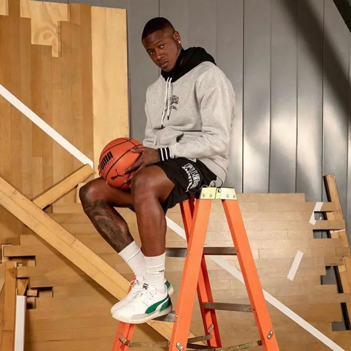 Rozier promoting Puma wearing a Clyde Hardwood design and their basketball. 