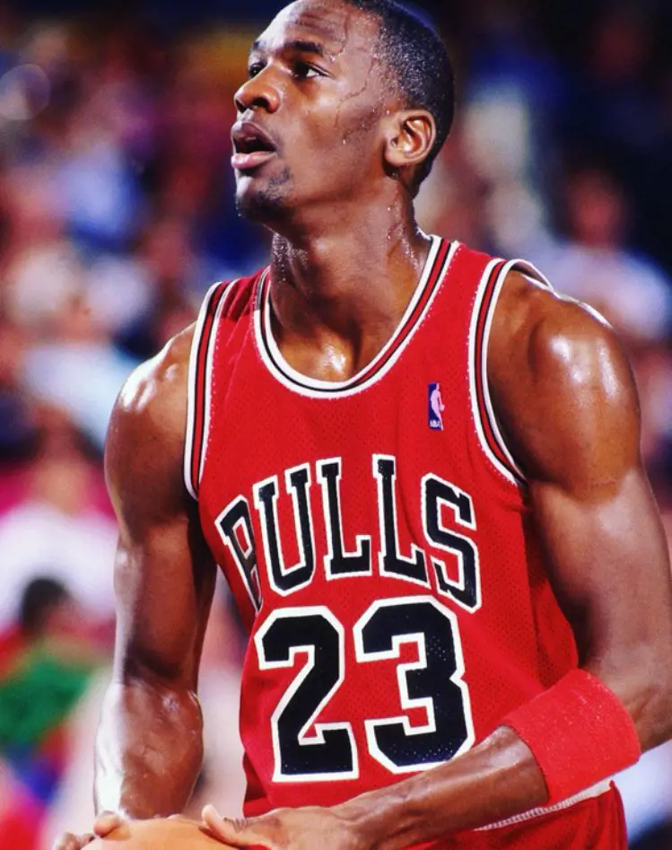 Michael Rocking His Athletic Build In The Bulls Jersey Holding A Basketball 